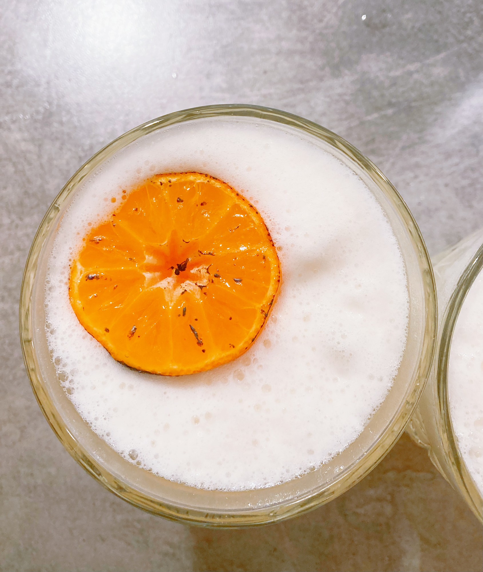 A whisky cocktail with an orange slice
