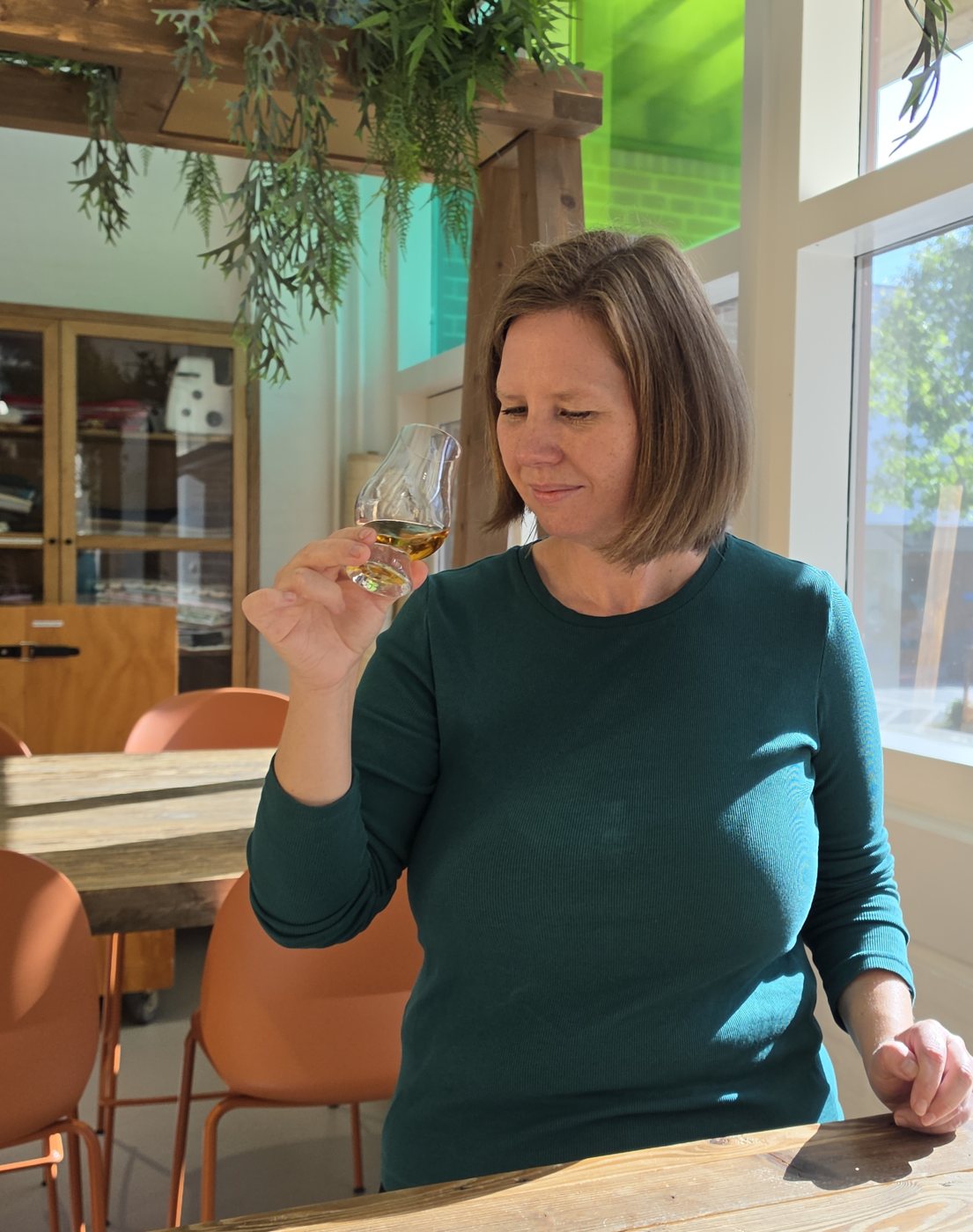 Louise studying a glass of whisky
